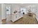 Open-concept dining area with seamless transition to the living room with hardwood floors at 132 W Orchid Ln, Chandler, AZ 85225