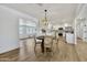 Bright dining area with hardwood floors, modern chandelier and open access to the kitchen at 132 W Orchid Ln, Chandler, AZ 85225