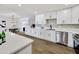 Bright kitchen featuring white cabinets, quartz counters, stainless appliances, and tile backsplash at 132 W Orchid Ln, Chandler, AZ 85225