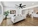 Bright living room features hardwood floors, modern fan, and open access to dining room and kitchen at 132 W Orchid Ln, Chandler, AZ 85225