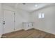 Utility room features wood-look floors, a window, and a cabinet with storage at 132 W Orchid Ln, Chandler, AZ 85225