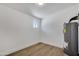 Clean utility room features wood-look floors and a water heater at 132 W Orchid Ln, Chandler, AZ 85225