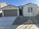 Charming single-story home featuring a neutral color palette, two car garage and desert landscaping at 17187 W Corrine Dr, Surprise, AZ 85388