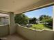 View from the balcony overlooking the lush green lawn and mature trees, creating a peaceful and inviting outdoor space at 1825 W Ray Rd # 2082, Chandler, AZ 85224