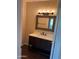 Bathroom featuring wood-look floors, vanity with a new sink, and a wood framed mirror at 1825 W Ray Rd # 2082, Chandler, AZ 85224