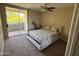 Bright bedroom with a ceiling fan, sliding glass doors to balcony, and comfortable carpet at 1825 W Ray Rd # 2082, Chandler, AZ 85224