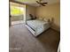Bright bedroom with a ceiling fan, sliding glass doors to balcony, and comfortable carpet at 1825 W Ray Rd # 2082, Chandler, AZ 85224