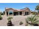 Stunning backyard featuring an outdoor patio, desert landscaping, and a covered hot tub at 19745 N Mountain Sage Ln, Surprise, AZ 85374