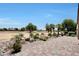 Beautiful backyard featuring desert landscaping, tiled patio and golf course views at 19745 N Mountain Sage Ln, Surprise, AZ 85374