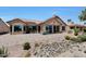 Beautiful backyard featuring a tiled patio, desert landscaping, and hot tub at 19745 N Mountain Sage Ln, Surprise, AZ 85374