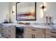 Close up shot of the bar area showcasing marble countertops and a built-in wine cooler at 19745 N Mountain Sage Ln, Surprise, AZ 85374
