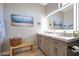 Bright bathroom featuring dual sinks, white marble countertop, and decorative details at 19745 N Mountain Sage Ln, Surprise, AZ 85374