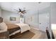 Relaxing bedroom featuring wood-look floors, ceiling fan, and plenty of closet space at 19745 N Mountain Sage Ln, Surprise, AZ 85374