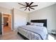 This cozy bedroom features a ceiling fan, closet, comfortable bed, and neutral wall colors at 19745 N Mountain Sage Ln, Surprise, AZ 85374