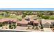 Beautiful desert home with lush landscaping, a paver driveway, and a tile roof with solar panels at 19745 N Mountain Sage Ln, Surprise, AZ 85374