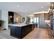 Modern kitchen with a large island, stainless steel appliances, and an open floor plan at 19745 N Mountain Sage Ln, Surprise, AZ 85374