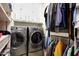 Well-organized laundry room with washer, dryer, and ample storage space at 19745 N Mountain Sage Ln, Surprise, AZ 85374