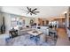 An open floor plan living room and kitchen with neutral decor, natural light, and hardwood floors at 19745 N Mountain Sage Ln, Surprise, AZ 85374