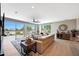 Open-concept living room featuring large windows with natural light, hardwood flooring, and comfortable seating at 19745 N Mountain Sage Ln, Surprise, AZ 85374