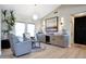 Inviting living room featuring a stylish bar area, light hardwood floors, and modern decor at 19745 N Mountain Sage Ln, Surprise, AZ 85374
