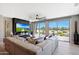 Bright living room featuring sliding glass doors leading to the backyard and a modern stone fireplace and television at 19745 N Mountain Sage Ln, Surprise, AZ 85374
