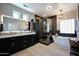 Luxurious bathroom featuring soaking tub, glass shower, and modern fixtures at 19745 N Mountain Sage Ln, Surprise, AZ 85374