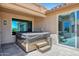 This cozy patio features a covered hot tub and easy access to the home's interior at 19745 N Mountain Sage Ln, Surprise, AZ 85374