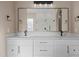 Elegant bathroom with a double vanity, marble countertop, and a sleek mirror at 28848 W Grand Ave, Wittmann, AZ 85361