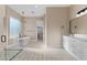 Elegant bathroom with a glass shower, modern vanity, and standalone tub beneath a stylish chandelier at 28848 W Grand Ave, Wittmann, AZ 85361
