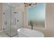 Modern bathroom featuring a glass shower, freestanding tub, and stylish fixtures at 28848 W Grand Ave, Wittmann, AZ 85361