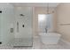 Modern bathroom featuring a glass shower, freestanding tub, and stylish fixtures at 28848 W Grand Ave, Wittmann, AZ 85361
