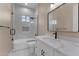 Bathroom featuring a marble vanity, frameless shower, and modern fixtures at 28848 W Grand Ave, Wittmann, AZ 85361