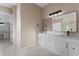 Bright bathroom featuring a dual sink vanity with white cabinets and a decorative tile floor at 28848 W Grand Ave, Wittmann, AZ 85361
