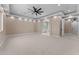 Spacious bedroom offers plush carpet, recessed lighting, ceiling fan, neutral colors, and an attached bathroom with soaking tub at 28848 W Grand Ave, Wittmann, AZ 85361