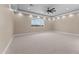 Spacious bedroom features carpet, recessed lighting, ceiling fan, neutral paint, large window, and abundant natural light at 28848 W Grand Ave, Wittmann, AZ 85361