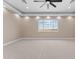 Bright bedroom with a large window, plush carpet, and modern ceiling fan at 28848 W Grand Ave, Wittmann, AZ 85361