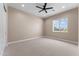 An empty bedroom showcasing a ceiling fan, recessed lighting, and a window letting in natural light at 28848 W Grand Ave, Wittmann, AZ 85361