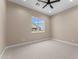 An empty bedroom showcasing a ceiling fan, recessed lighting, and a window letting in natural light at 28848 W Grand Ave, Wittmann, AZ 85361