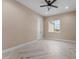An empty bedroom showcasing a ceiling fan, recessed lighting, and a window letting in natural light at 28848 W Grand Ave, Wittmann, AZ 85361