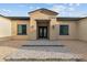 Exterior view of a home featuring a well-manicured lawn and a stone entryway at 28848 W Grand Ave, Wittmann, AZ 85361