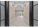 The entry foyer features an arched opening, wood look tile flooring, and a grand entrance at 28848 W Grand Ave, Wittmann, AZ 85361