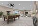 Game room featuring a pool table, herringbone floors, and a comfortable lounge area with a TV at 28848 W Grand Ave, Wittmann, AZ 85361