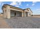 A well-lit three-car garage and large driveway with a paver finish at 28848 W Grand Ave, Wittmann, AZ 85361