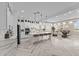 Bright kitchen boasts white cabinets, quartz counters and island, and herringbone wood floors at 28848 W Grand Ave, Wittmann, AZ 85361