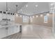 Bright living room showcases an open layout, herringbone floors, and modern finishes connecting to the kitchen at 28848 W Grand Ave, Wittmann, AZ 85361
