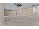Large living room showcasing herringbone floors, neutral walls, and an open layout leading to other rooms at 28848 W Grand Ave, Wittmann, AZ 85361