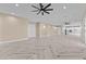 Open living space highlighting herringbone floors, ceiling fan, and flow to the kitchen area at 28848 W Grand Ave, Wittmann, AZ 85361