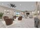 Staged living room featuring herringbone floors, neutral tones, and comfortable seating arrangement at 28848 W Grand Ave, Wittmann, AZ 85361