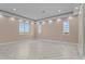 Bright living room featuring herringbone floors, recessed lighting, neutral paint, and large windows for natural light at 28848 W Grand Ave, Wittmann, AZ 85361