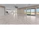 Open living room showcasing herringbone floors, natural light, and seamless flow into the modern kitchen at 28848 W Grand Ave, Wittmann, AZ 85361